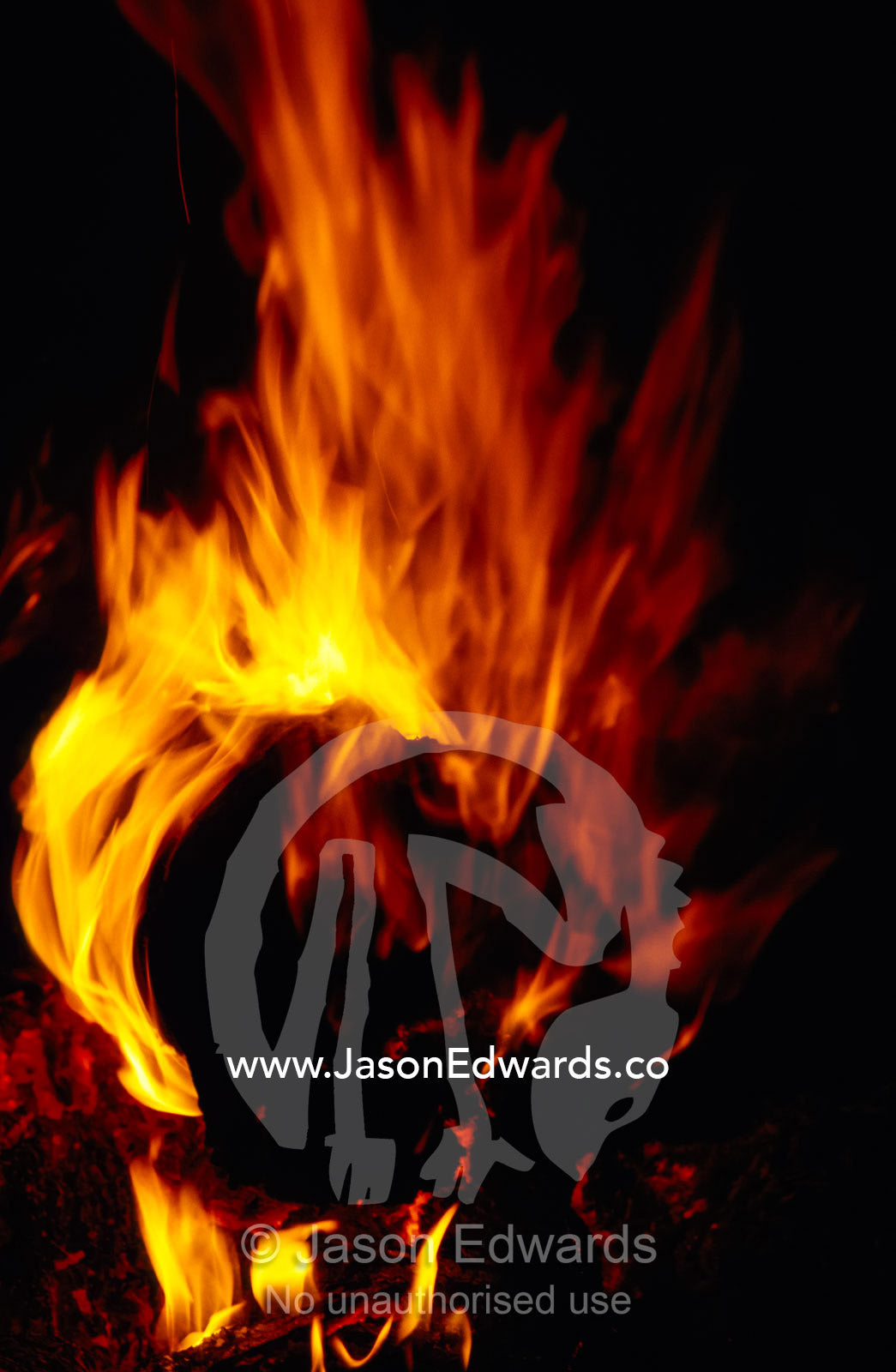 Red, orange and yellow flickering flames from a desert campfire. Eyre Creek, South Australia.