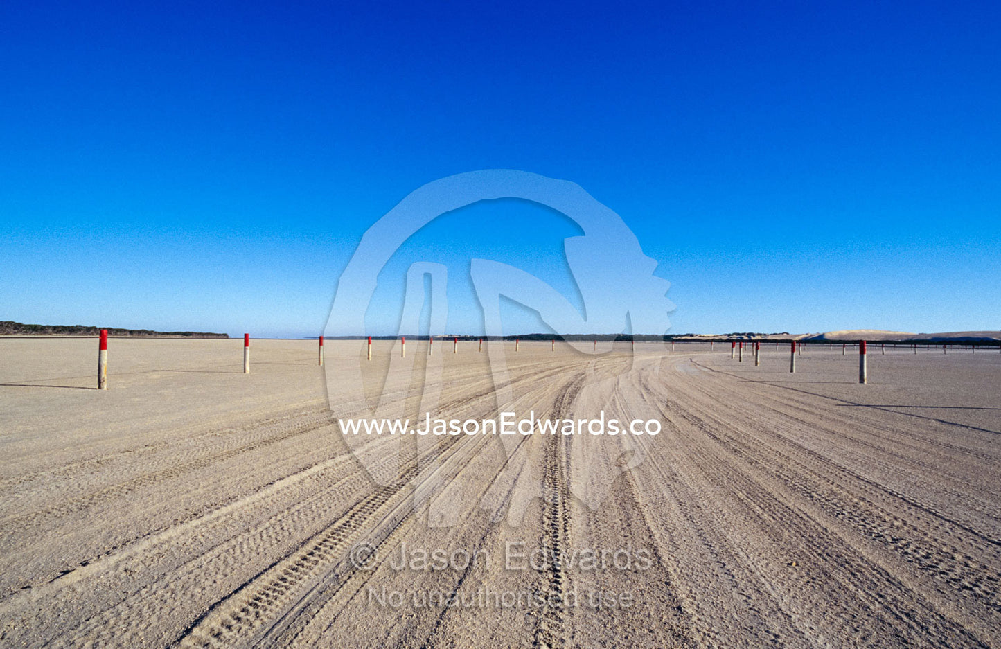 Tracks and markers for car access routes along a vast sandy beach. Coorong National Park, Younghusband Penninsula, South Australia.