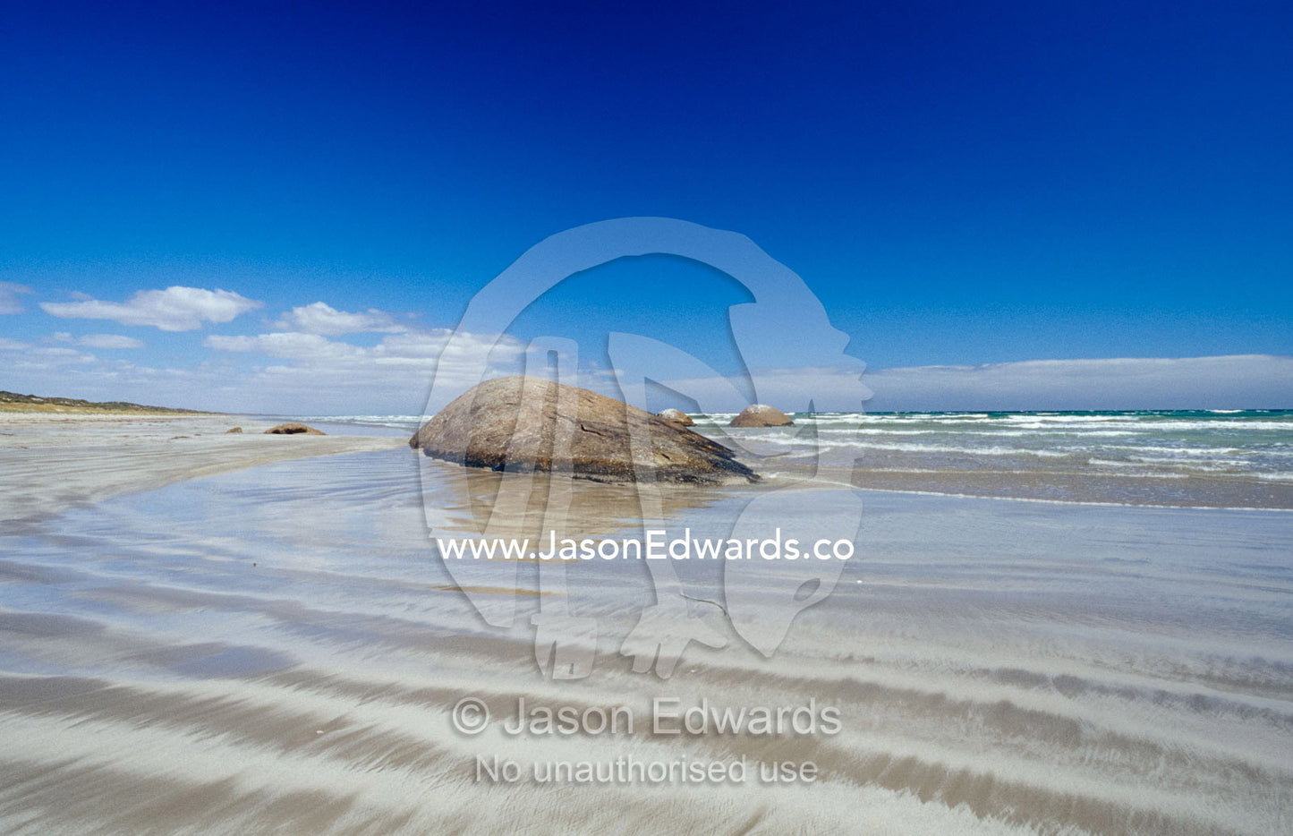 Granite rock formations emerging from the tidal flat at low tide. The Granites Kingston South East, South Australia.