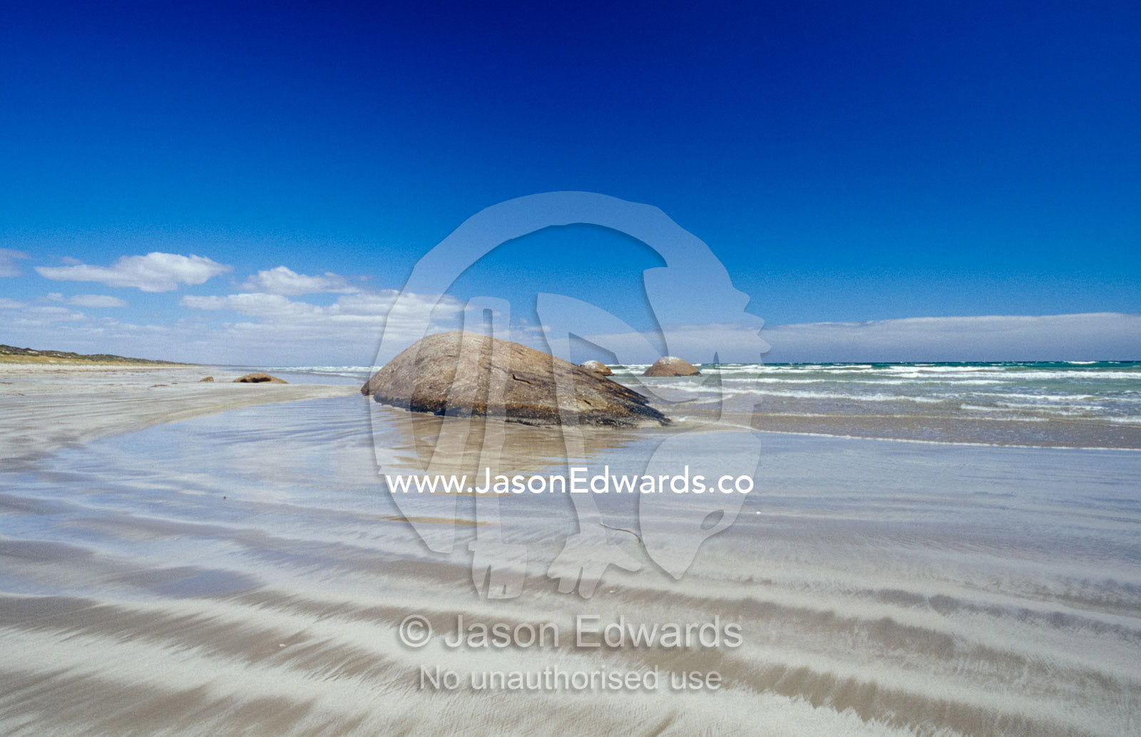 Granite rock formations emerging from the tidal flat at low tide. The Granites Kingston South East, South Australia.