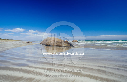Granite rock formations emerging from the tidal flat at low tide. The Granites Kingston South East, South Australia.
