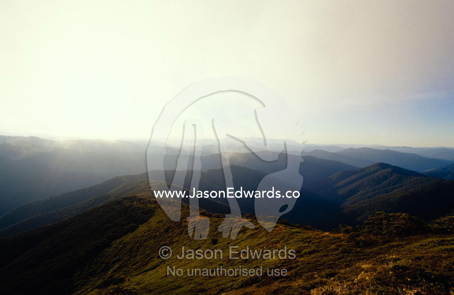 Alpine mountain ridges fade into the distant haze. Alpine National Park, Victoria, Australia.