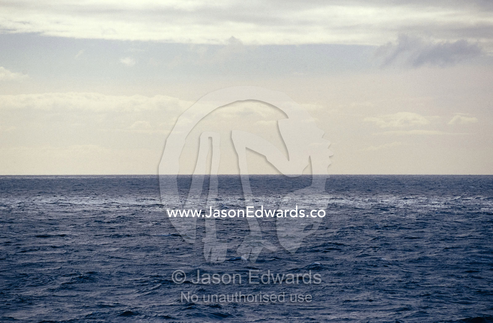 A calm, vast ocean in dappled shadow and light. Bass Strait, Victoria, Australia.