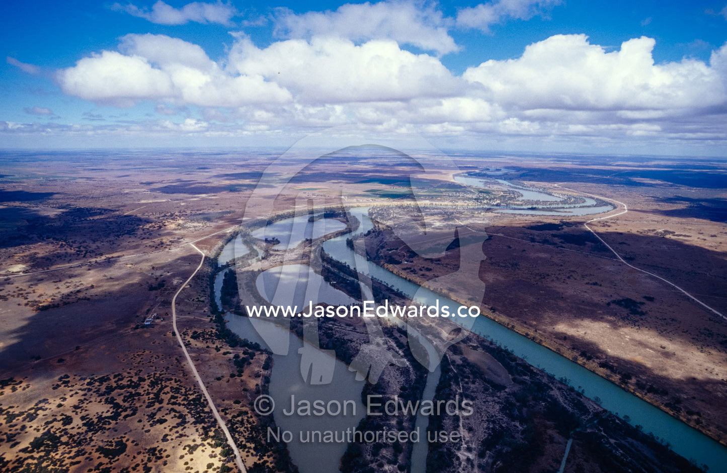 Aerial of the winding Murray River, wetlands and cloud formations. Riverina, North East South Australia.