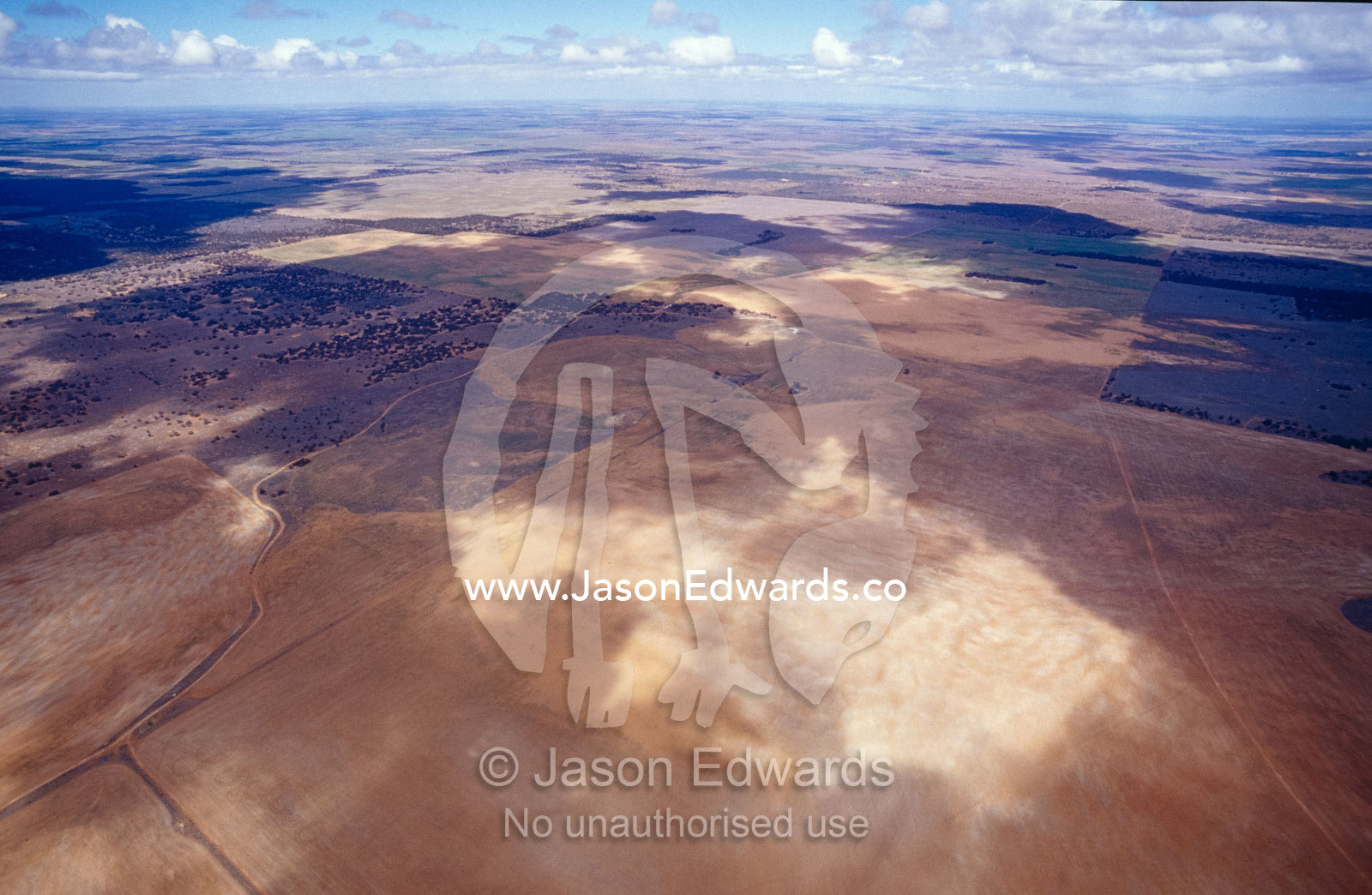Aerial of farmland in drought with cloud shadow patterns. North Eastern outback, South Australia.