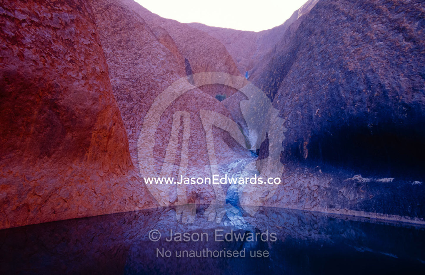 A waterhole oasis and Aboriginal sacred site at the base of Uluru. Uluru, Kata Tjuta, National Park, Northern Territory, Australia.