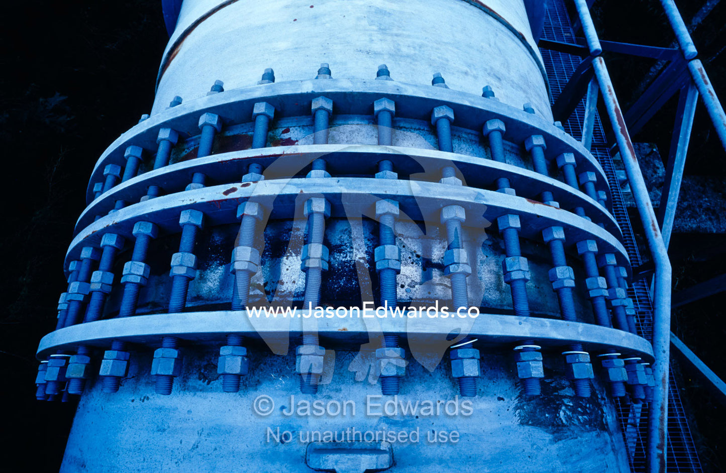 A large irrigation water pipe with many screws and bolts. Yellingbo Nature Conservation Reserve, Victoria, Australia.
