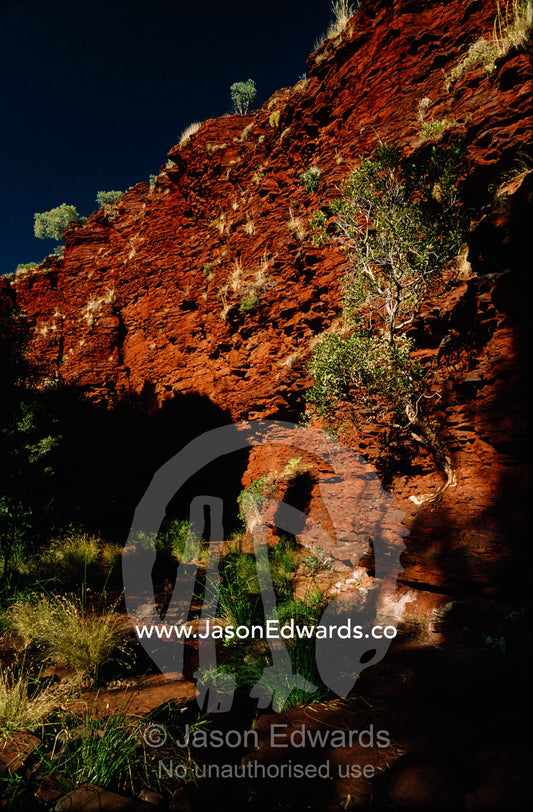 Deep red volcanic walls in a desert gorge. Hamersley Range, Karijini National Park, Western Australia.