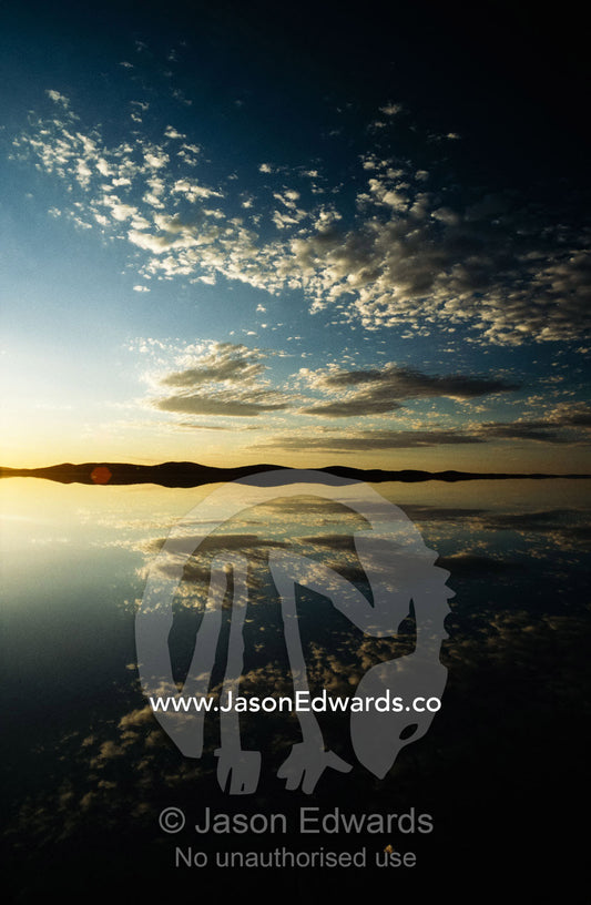 Clouds reflected in flooded Lake Gairdner, a salt lake at sunset. Gawler Ranges National Park, South Australia.