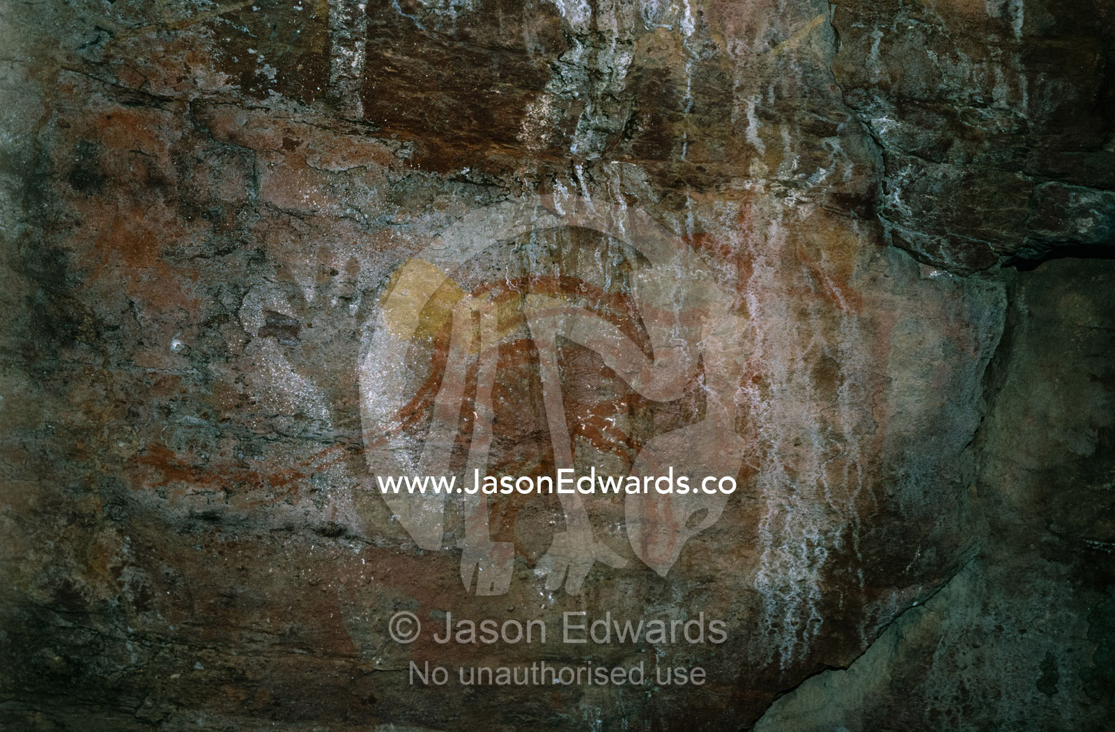 Ancient aboriginal cave paintings of a hand silhouette and kangaroo. Kakadu National Park, Northern Territory, Australia.