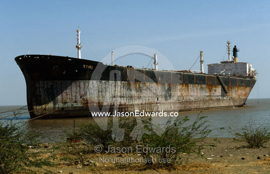 A tied up tanker awaiting dismantling near a ship breaking yard. Alang Ship Breaking Yards, Gujarat State, India.