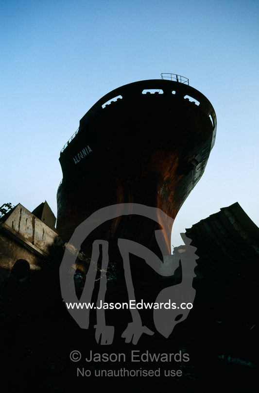 A tanker awaiting dismantling at a ship breaking yard. Alang Ship Breaking Yards, Gujarat State, India.