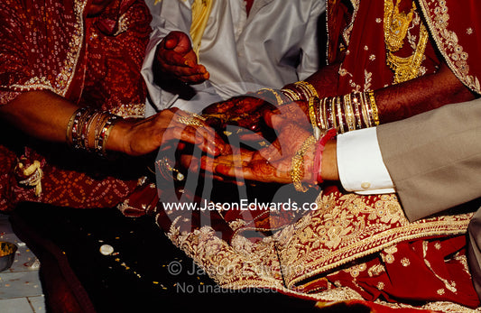 The exchange of hands during a Hindu wedding ceremony. Sawai Madhopur, Rajasthan State, India.