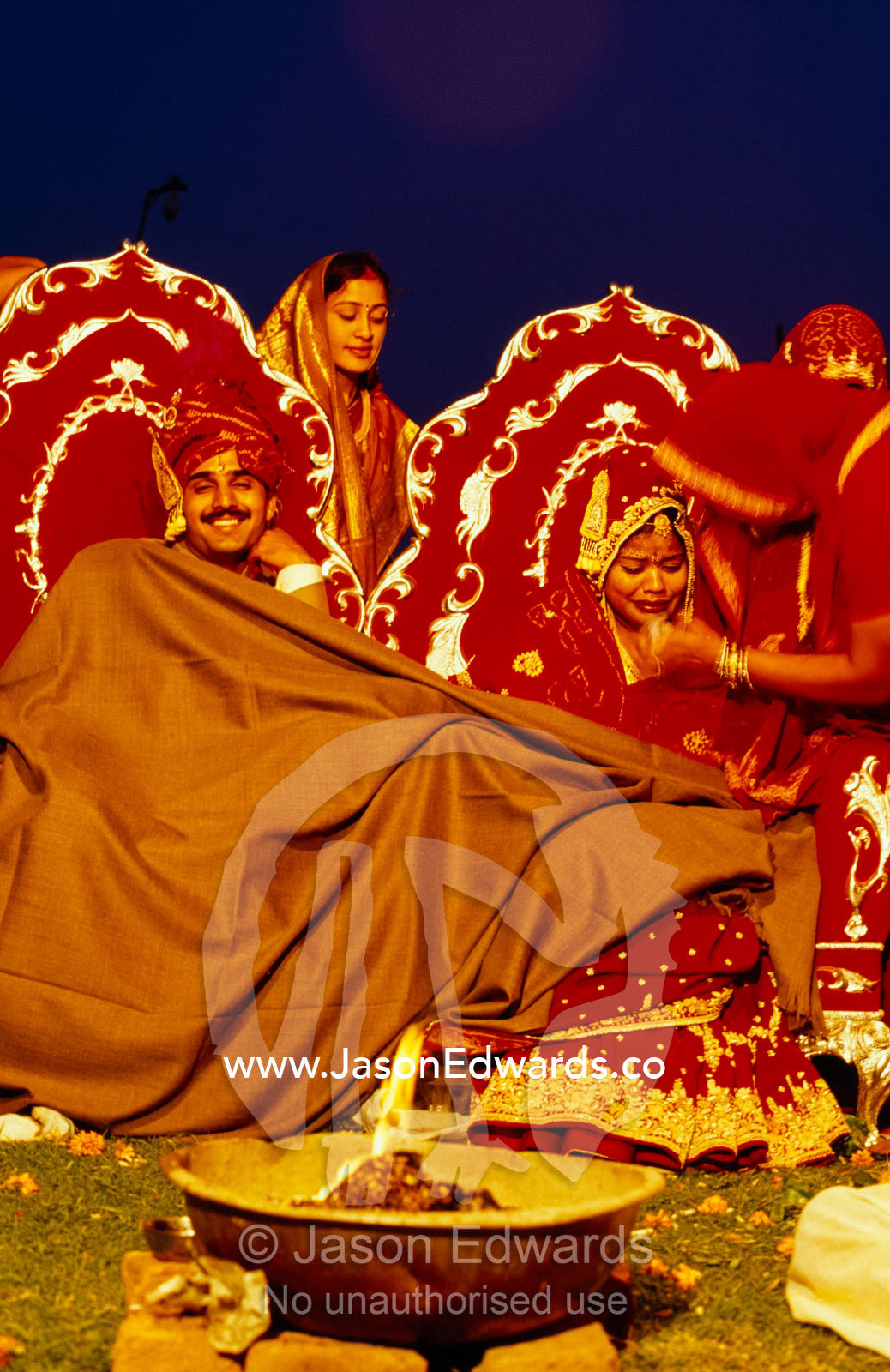 A bride cries as she prepares to leave her family at her wedding. Sawai Madhopur, Rajasthan State, India.