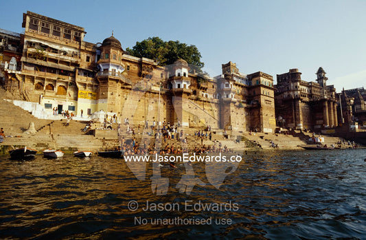 Crowds bathing and on the steps leading into the Ganges River. Varanasi (Benares), India.