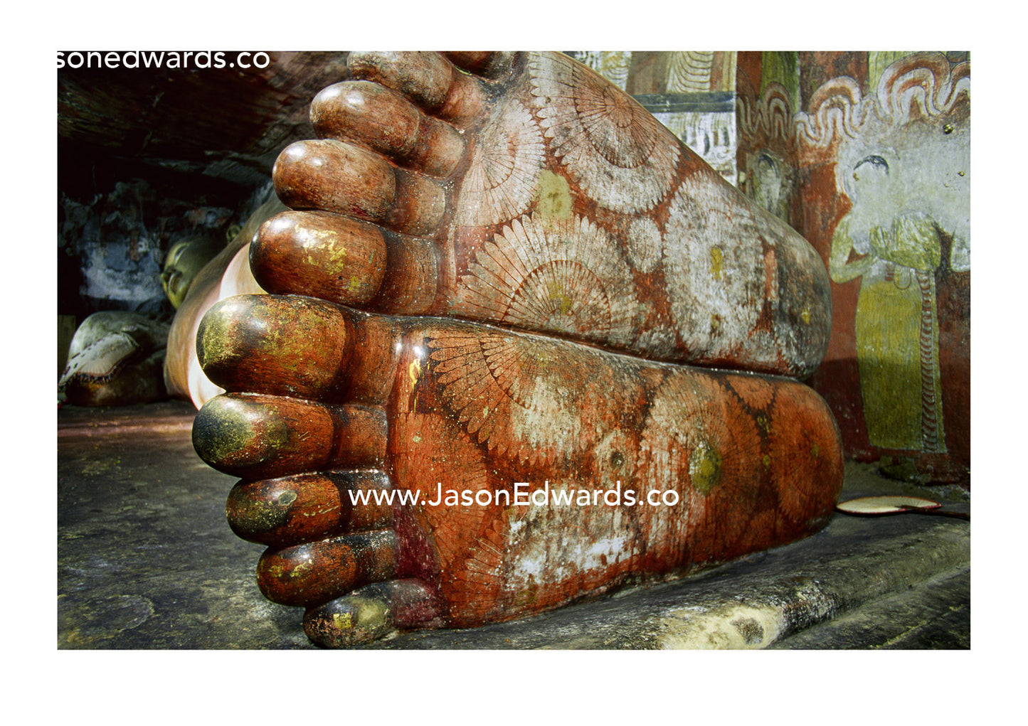 The feet of a 1st century reclining stone  Buddha in a cave temple. Dambulla Buddhist Cave Temple, Sri Lanka.