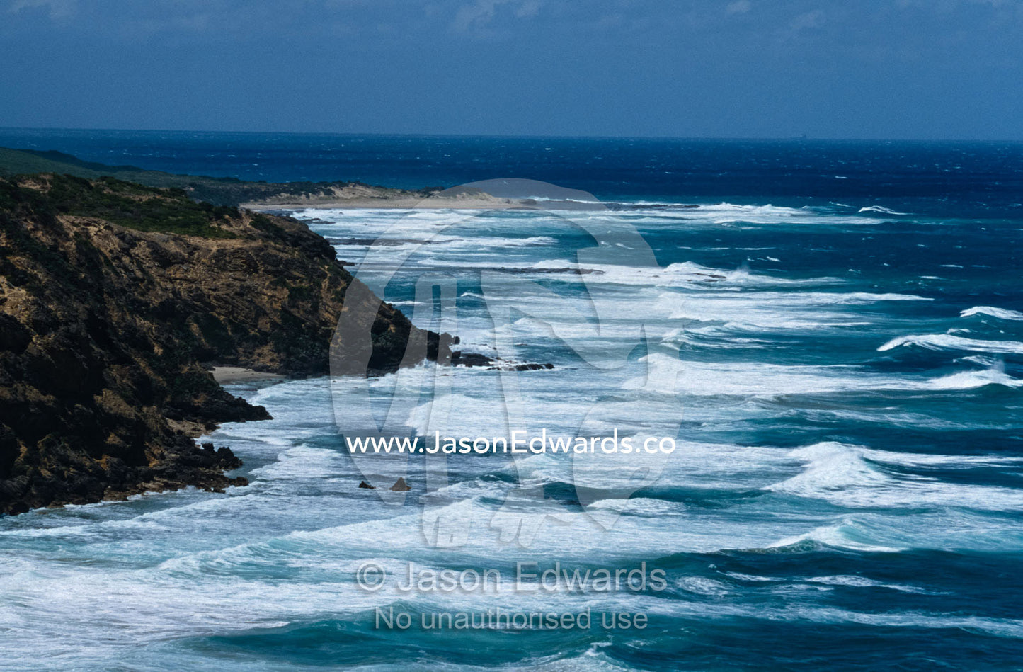 Incessant waves roll in on a remote and rugged coastline. Cape Otway National Park, Victoria Australia.