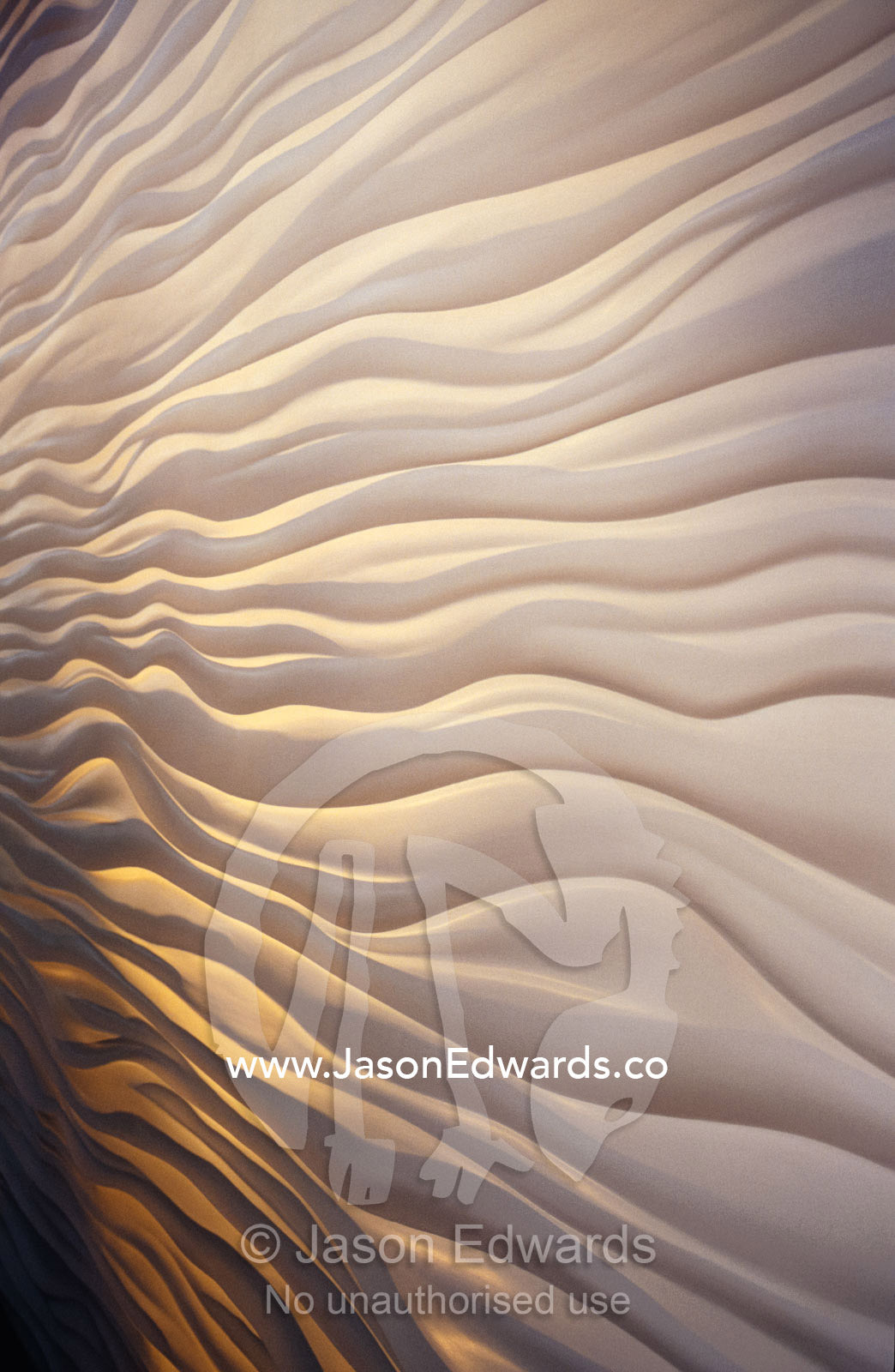 Lighting illiuminates an architectural display of waves in a wall. Carlton Gardens, Victoria, Australia.