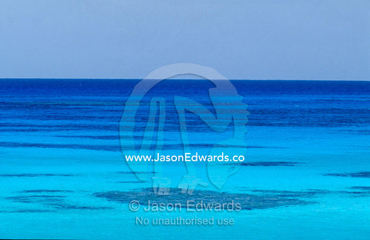 Rich turquoise seas and coral reefs surround remote tropical islands. East Diamond Island, Coral Sea Island Territory, Australia.