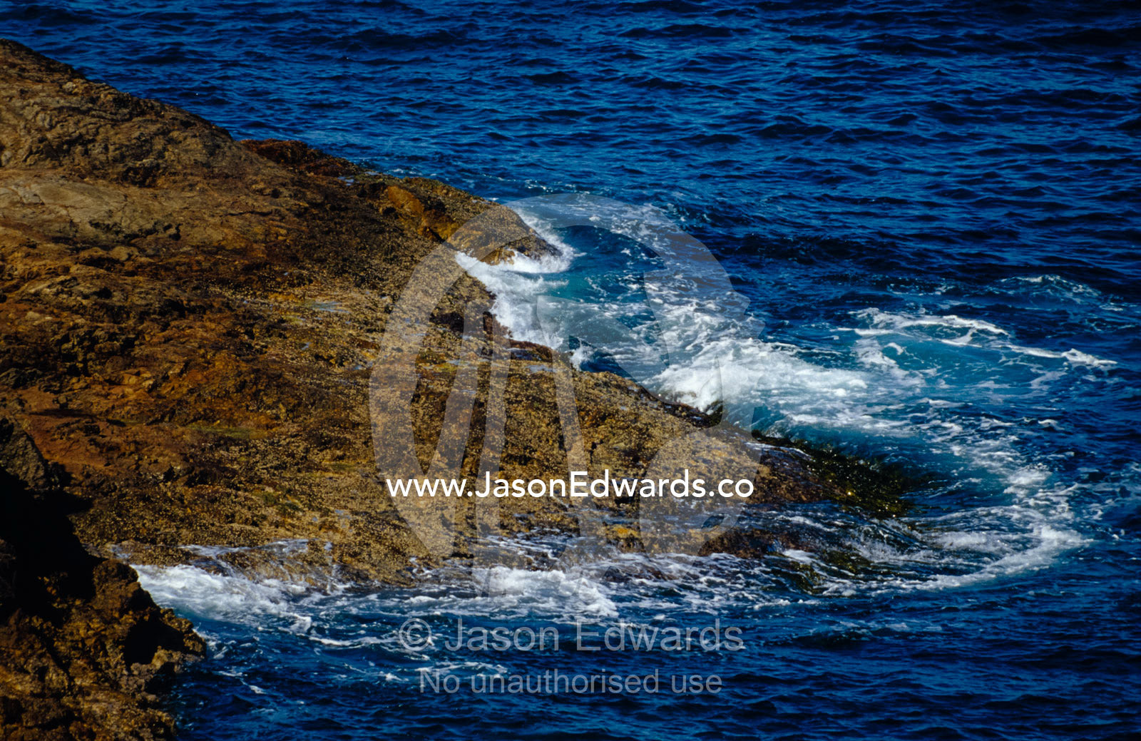 Waves wash over a rock reef at high tide. Ben Boyd National Park, New South Wales, Australia.