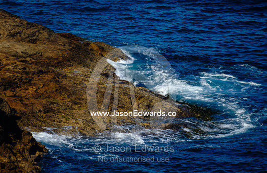 Waves wash over a rock reef at high tide. Ben Boyd National Park, New South Wales, Australia.