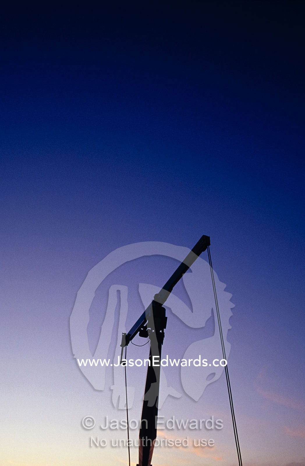 A silhouette of a maintenance crane atop the Eureka Tower at sunset. Melbourne, Victoria, Australia.
