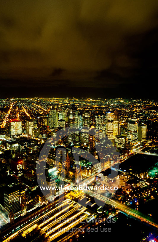 Winter storm clouds roll in over the Melbourne city skyline at night. Melbourne, Victoria, Australia.