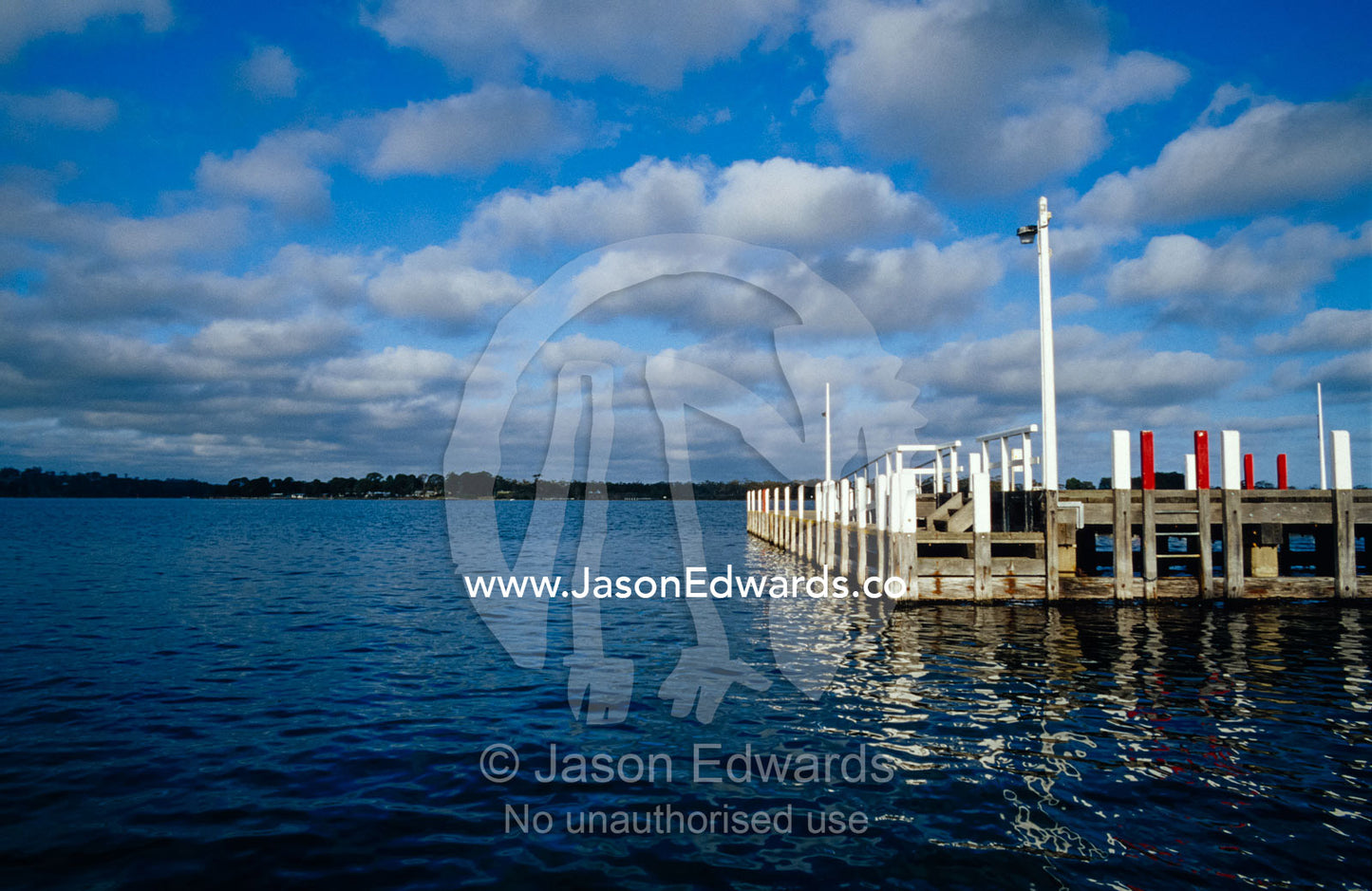 A small jetty and boat habour on the Gippsland Lakes on a sunny day. Metung, Gippsland Lakes, Victoria, Australia