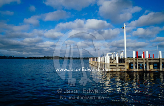 A small jetty and boat habour on the Gippsland Lakes on a sunny day. Metung, Gippsland Lakes, Victoria, Australia