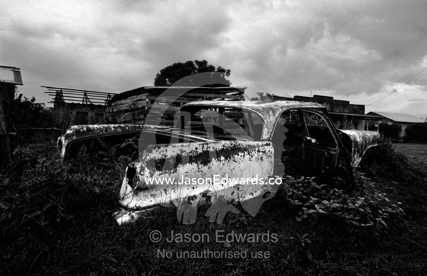 An antique American car rusting away in a small African village. Kisoro District, South Western Uganda.
