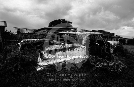 An antique American car rusting away in a small African village. Kisoro District, South Western Uganda.