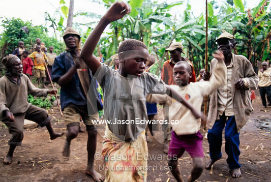 Displaced Batwa Forest People dancing at a cow initiation ceremony. Kisoro District, South Western Uganda.