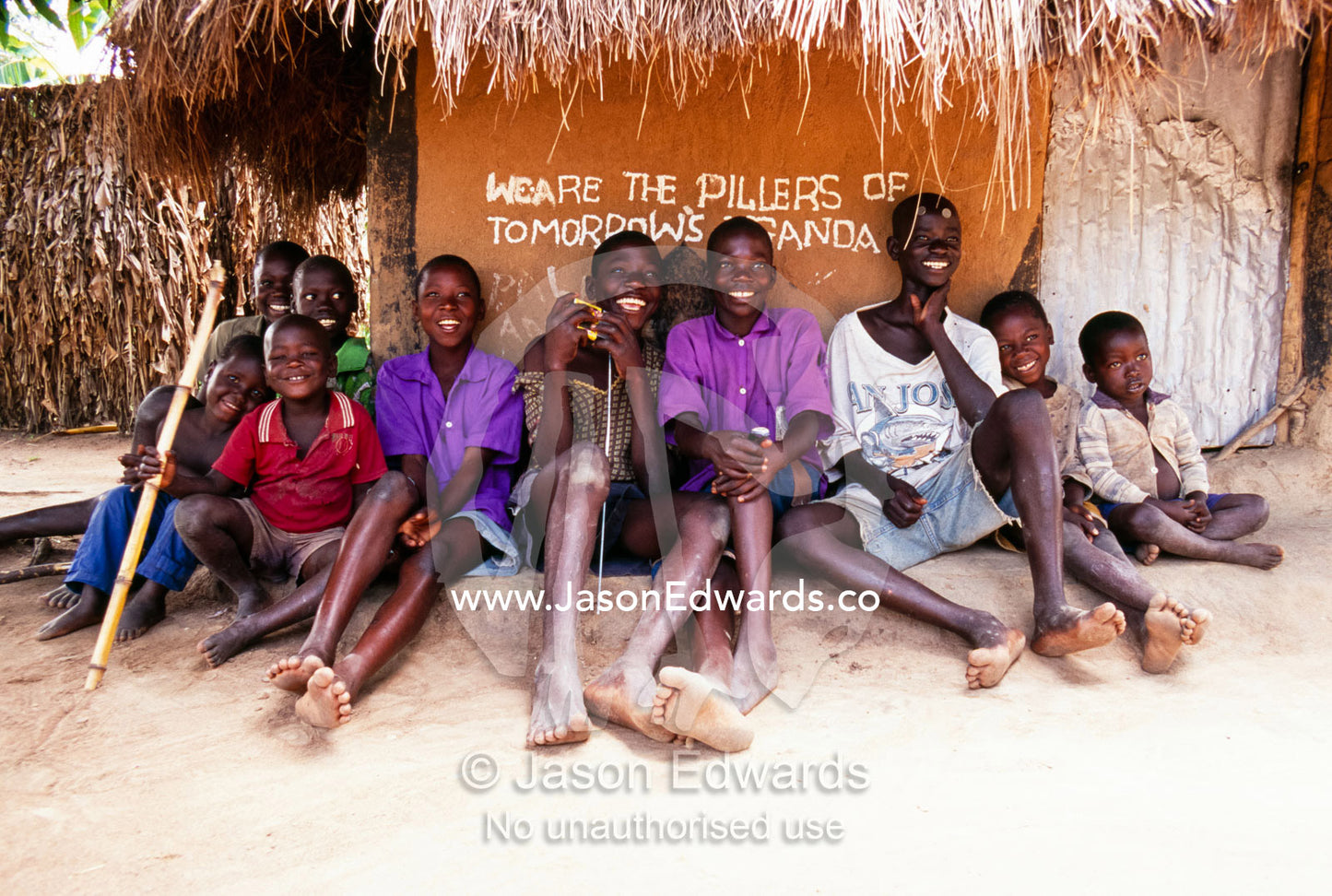 Children rest under graphics  We are the pillars of tomorrows Uganda . Tororo District, Uganda.