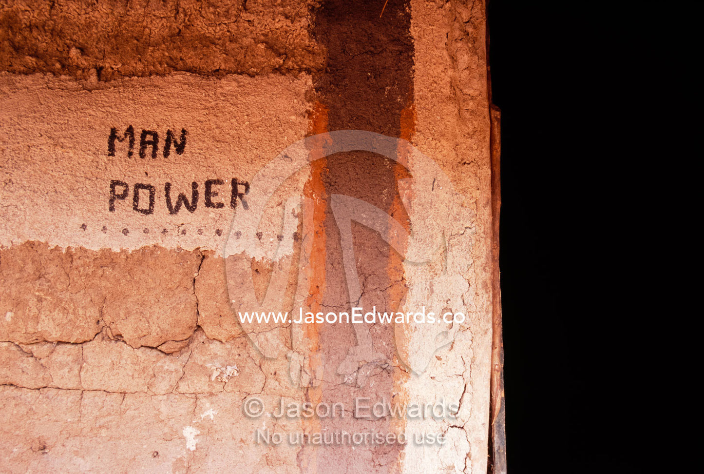 Man Power decoratively painted on the wall of an African mud hut. Tororo District, Uganda.
