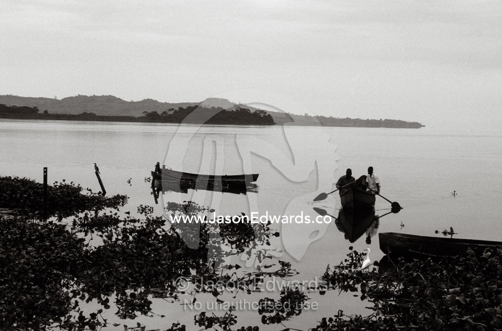 Fishermen return to the shore of Lake Victoria from a night's fishing. Kampala, Lake Victoria, Uganda.