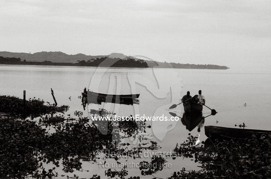 Fishermen return to the shore of Lake Victoria from a night's fishing. Kampala, Lake Victoria, Uganda.