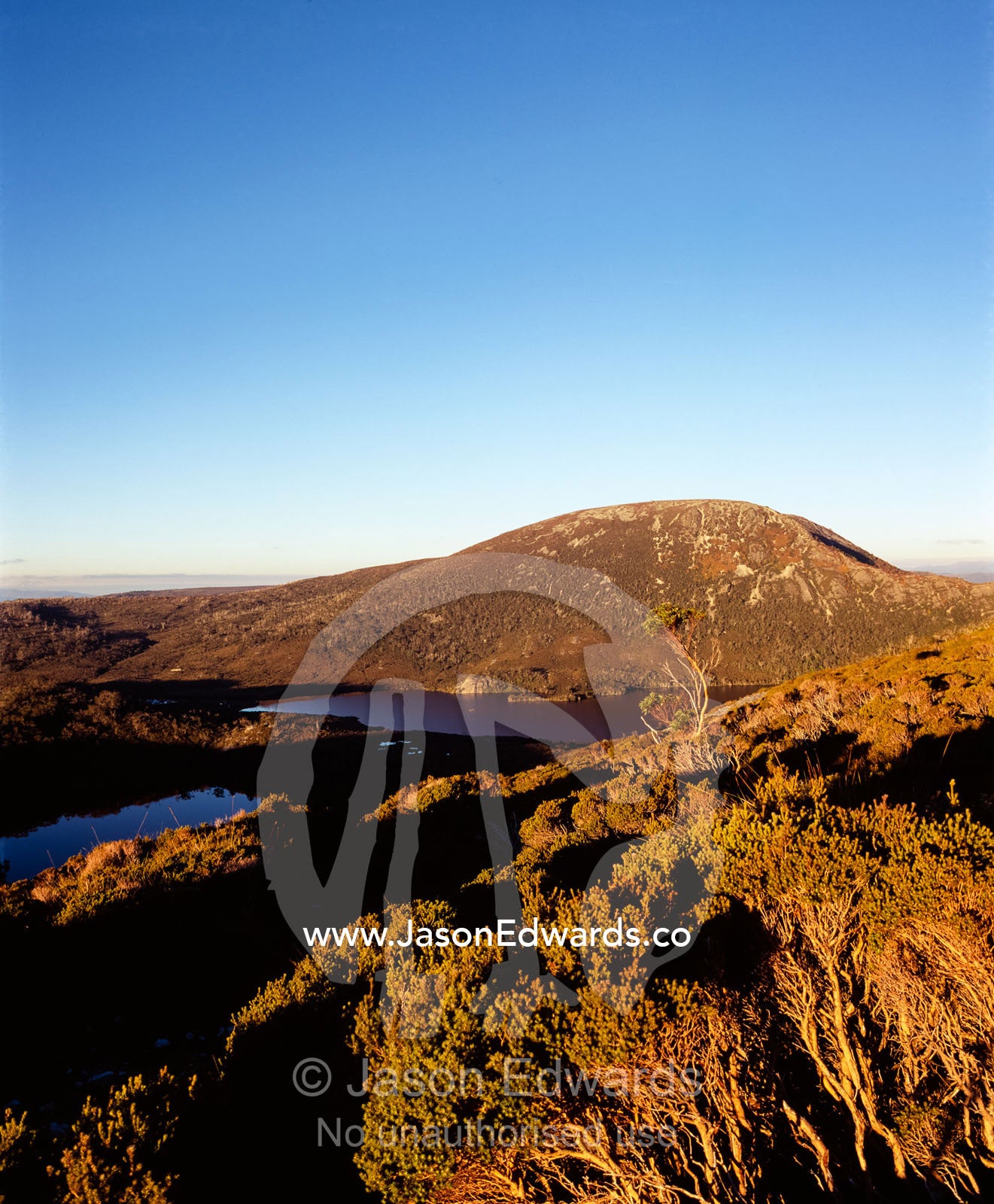 Sunset caresses the summit of Mount Campbell from Marions Lookout. Cradle Mountain, Lake St Clair National Park, Tasmania, Australia.