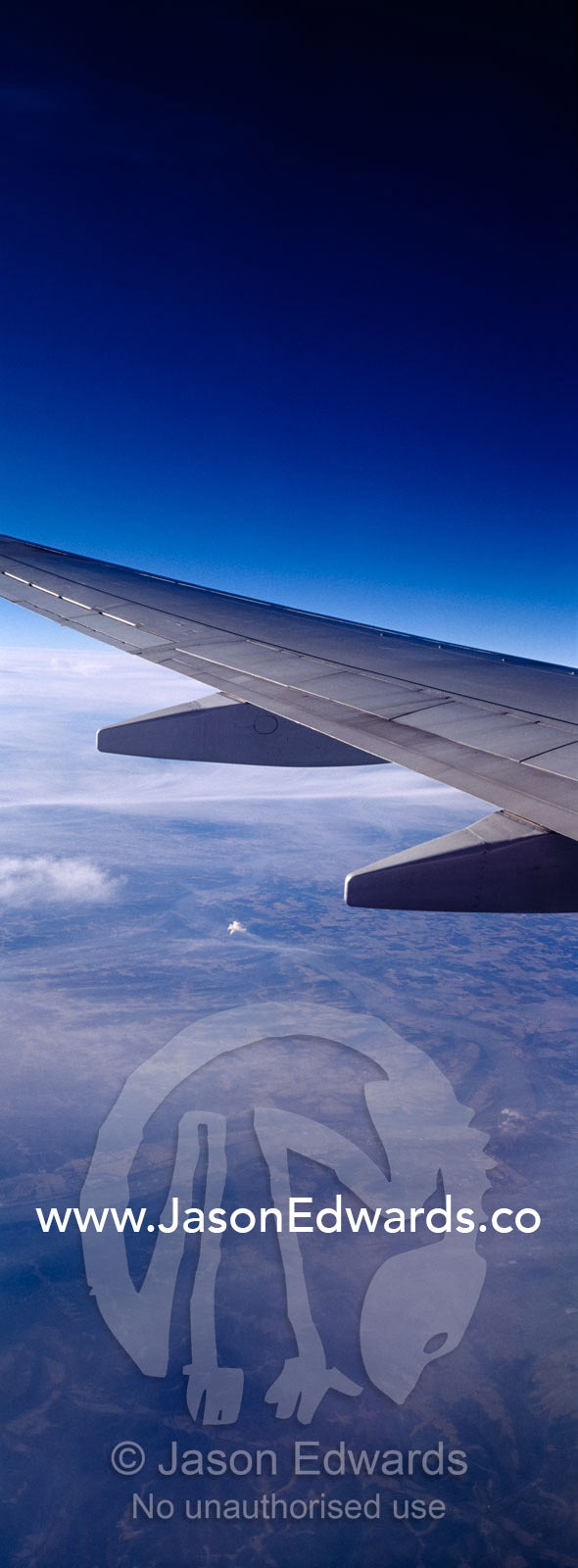 A passenger aircraft wing in flight over the USA and power stations. In flight over the United States of America, USA.