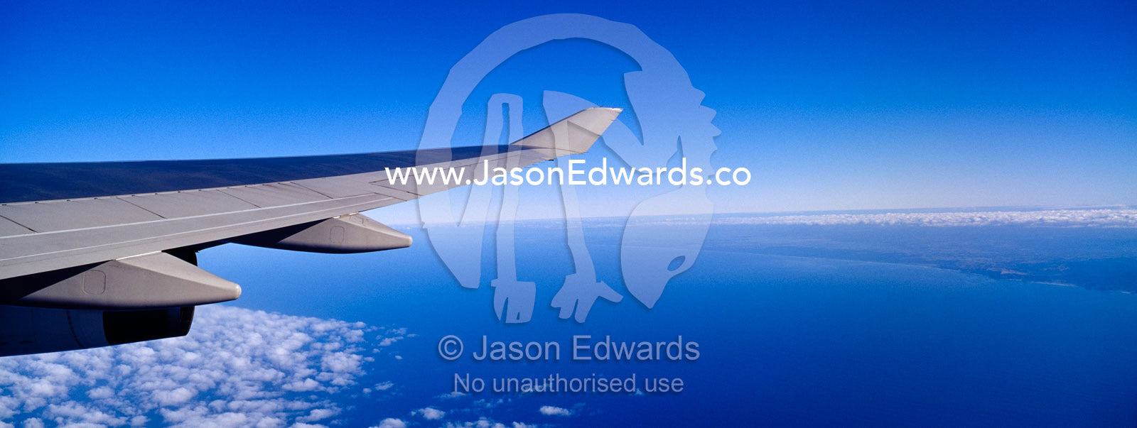 A passenger aircraft wing in flight over the the west coast of the USA In flight over the United States of America, USA.