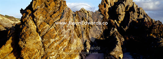 Razor sharp rocks greet the Southern Ocean where it smashes the coast. South West Conservation Area, Tasmania, Australia.