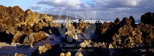 Razor sharp rocks greet the Southern Ocean where it smashes the coast. South West Conservation Area, Tasmania, Australia.