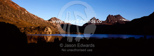 Cradle mountain reflected in the still waters of Dove Lake at sunset. Cradle Mountain Lake St Clair National Park, Tasmania, Australia.
