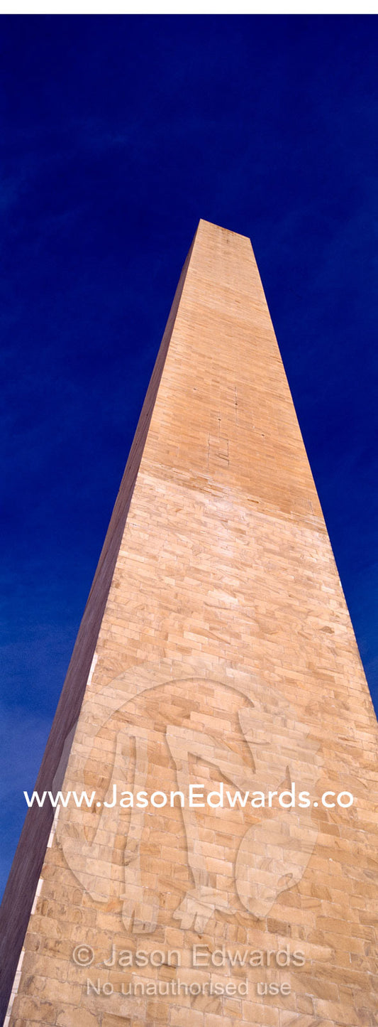 The Washington Monument stands tall in a clear, blue winter sky. Washington DC, USA, United States of America.
