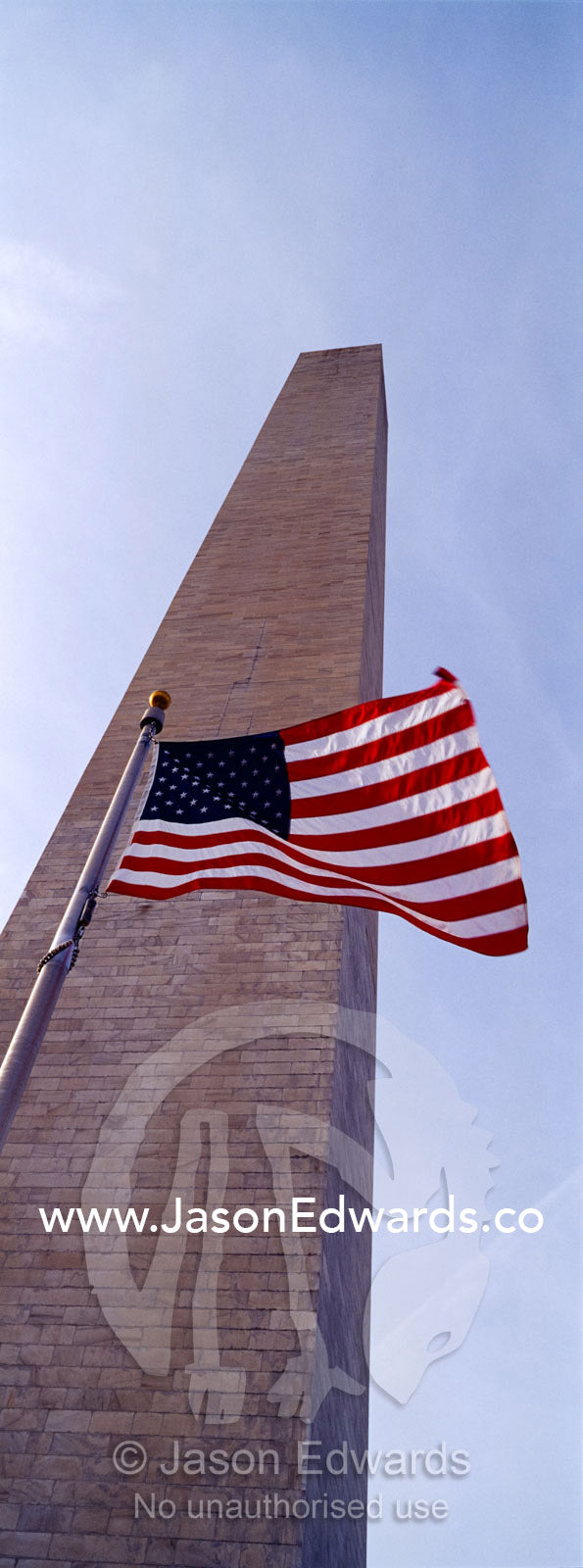 The American flag, Old Glory, flies near the Washington Monument. Washington DC, USA, United States of America.