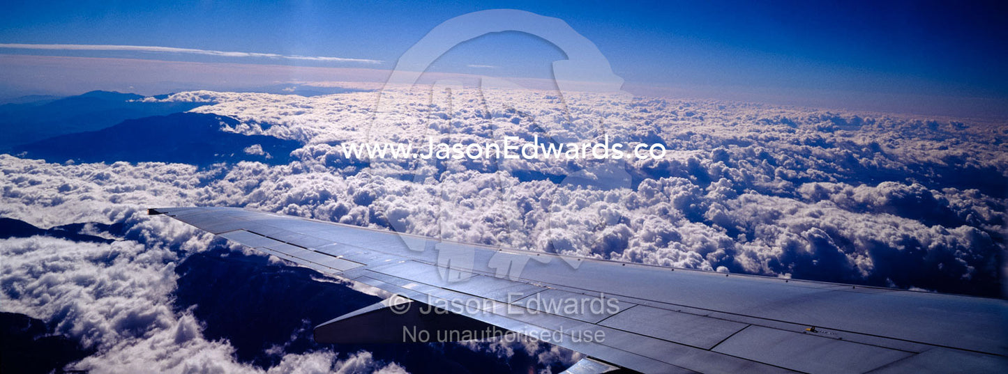 A passenger aircraft wing in flight over storm clouds. Central United States of America.