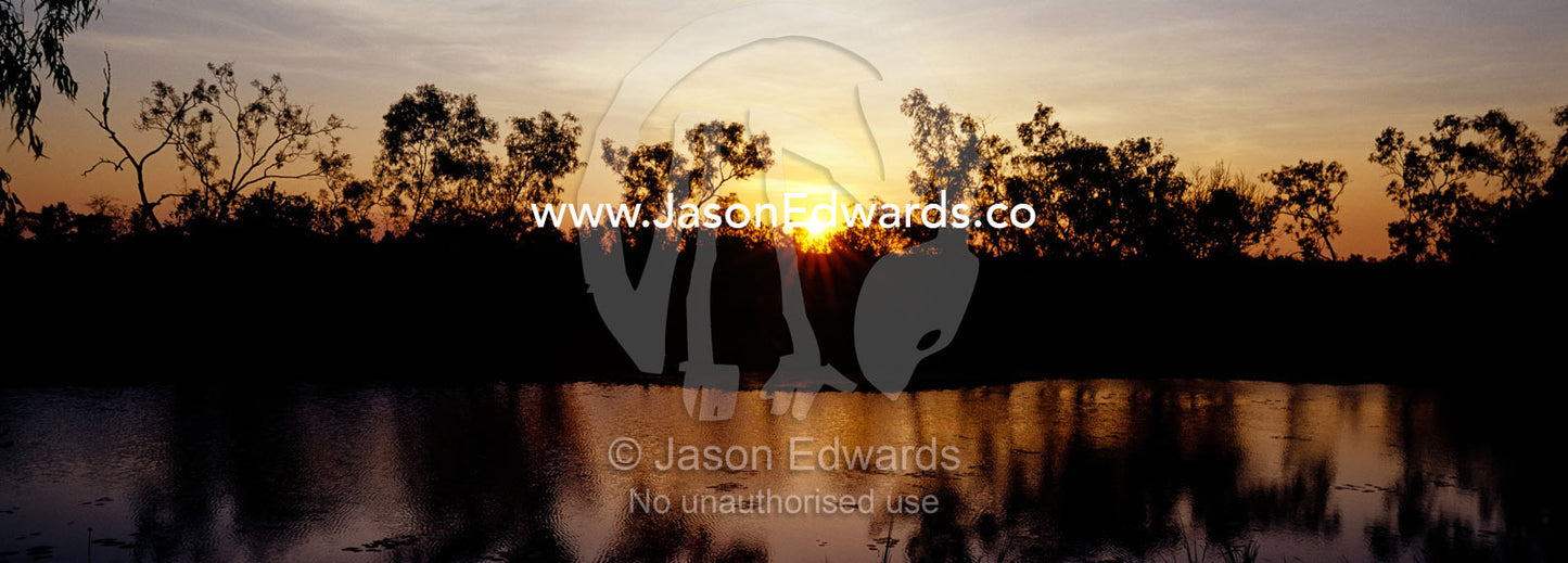 Sunset over a still billabong wetland in the Gulf of Carpentaria. Limmen National Park, Northern Territory, Australia.