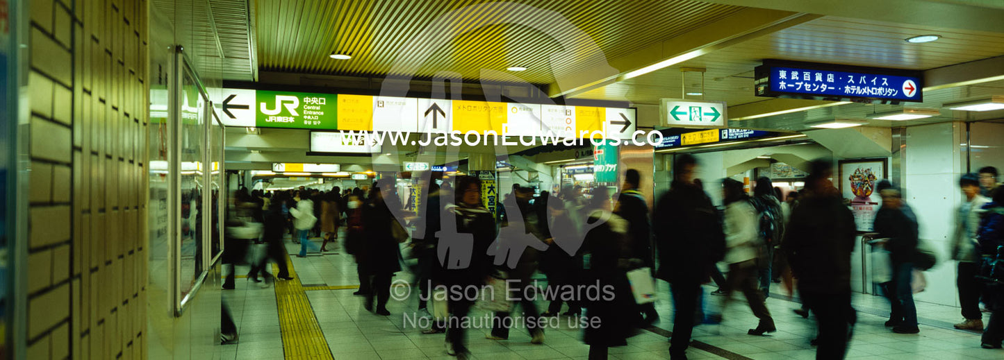 Commuters race between platforms to catch trains at Ikebukuro Station. Ikebukuro Station, Tokyo, Japan.