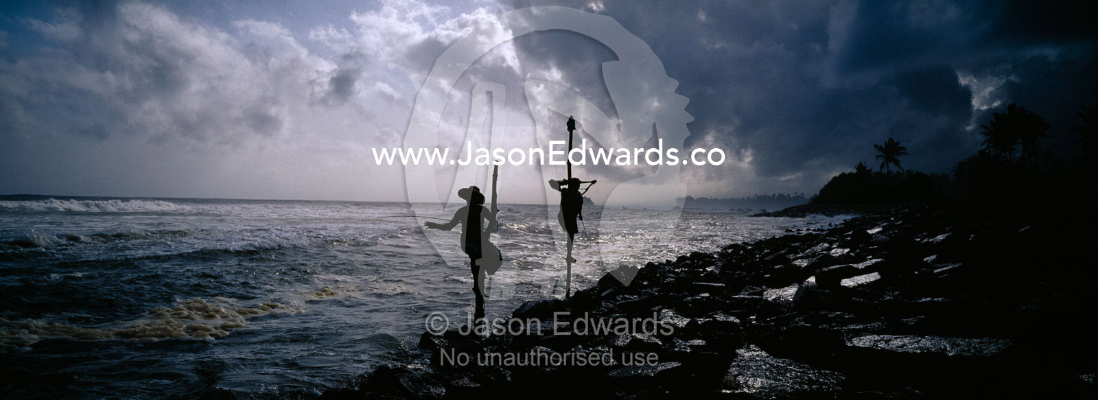 Traditional pole fishermen await the onset of a tropical storm. Weligama Bay, Sri Lanka.