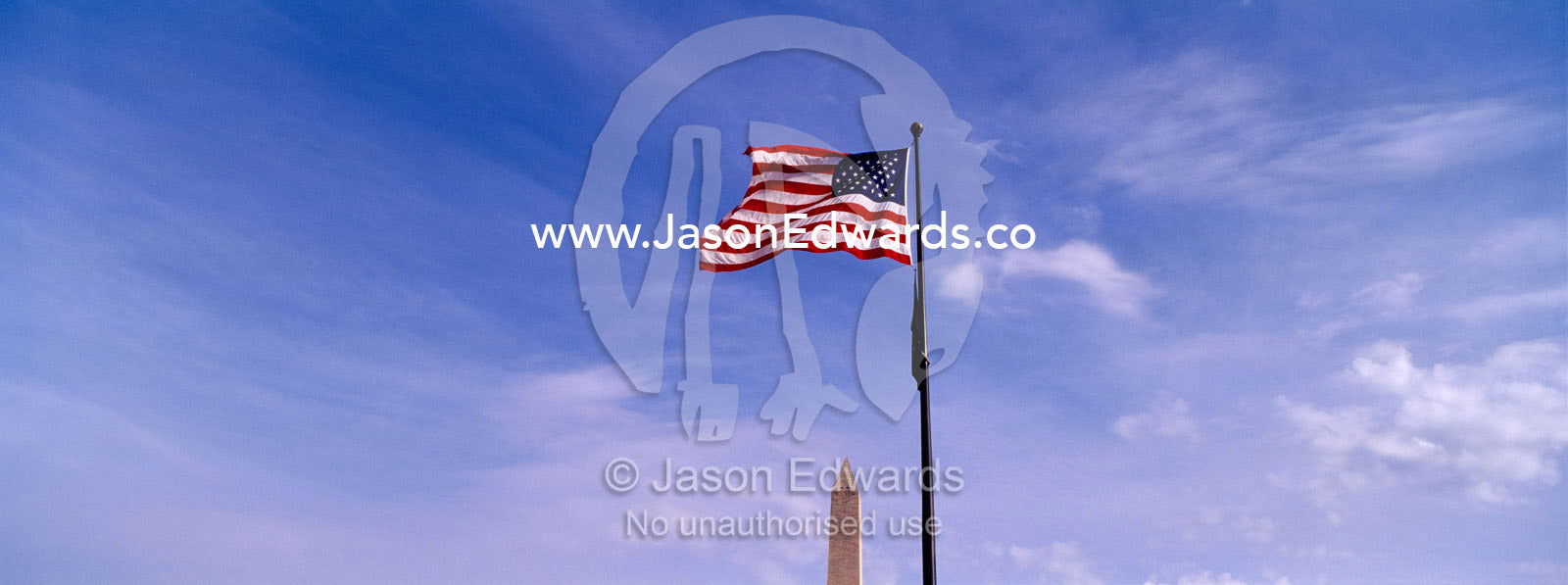 An American flag flies proudly at the Washington Monument. Washington DC, USA, United States of America.