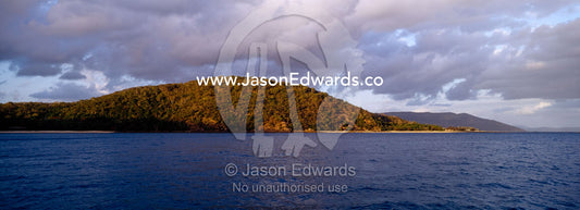 Dawn rises over remote tropical islands in the Whitsunday Passage. Whitsunday Islands, Queensland, Australia.